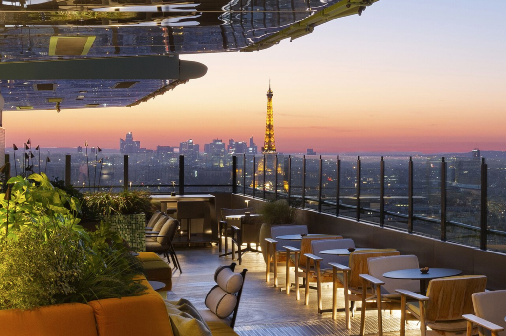 view of the eiffel tower at sunset from the rooftop of skybar at hotel pullman montparnasse in paris