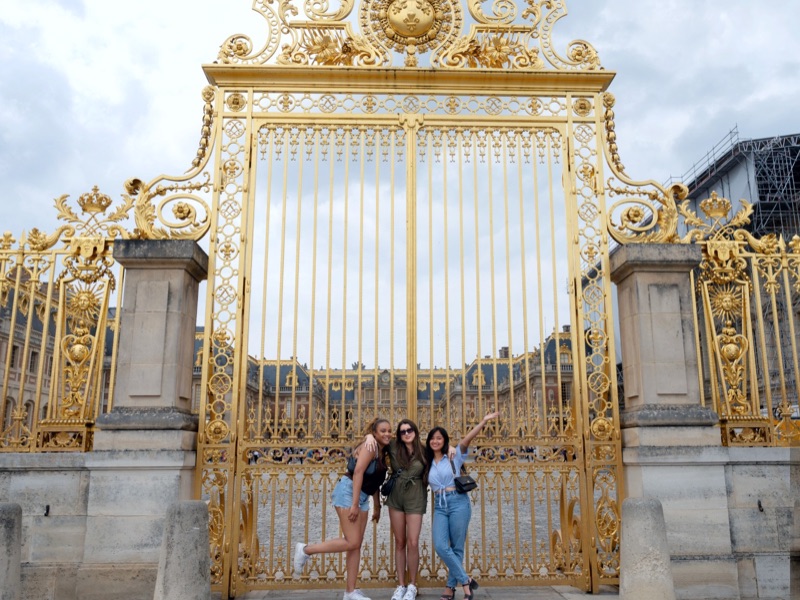 group photo at the gates of chateau de versailles